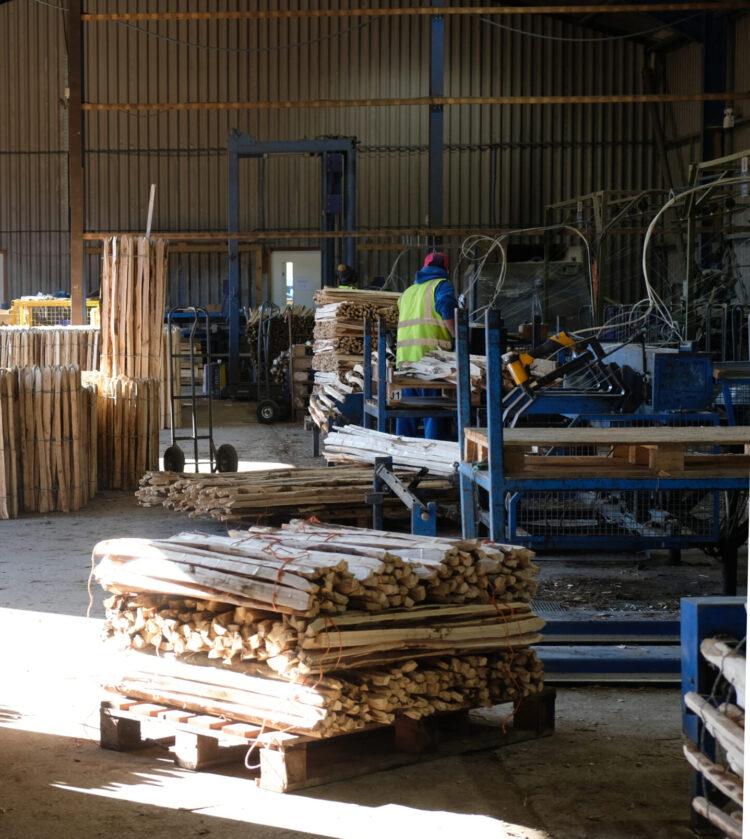stacks of chestnut pale fencing in the Torry Hill Chestnut Fencing factory